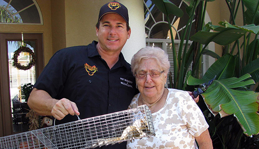 Scared Grandma and Pest Control Expert Holding Squirrel He Removed from Her House in Treasure Island FL